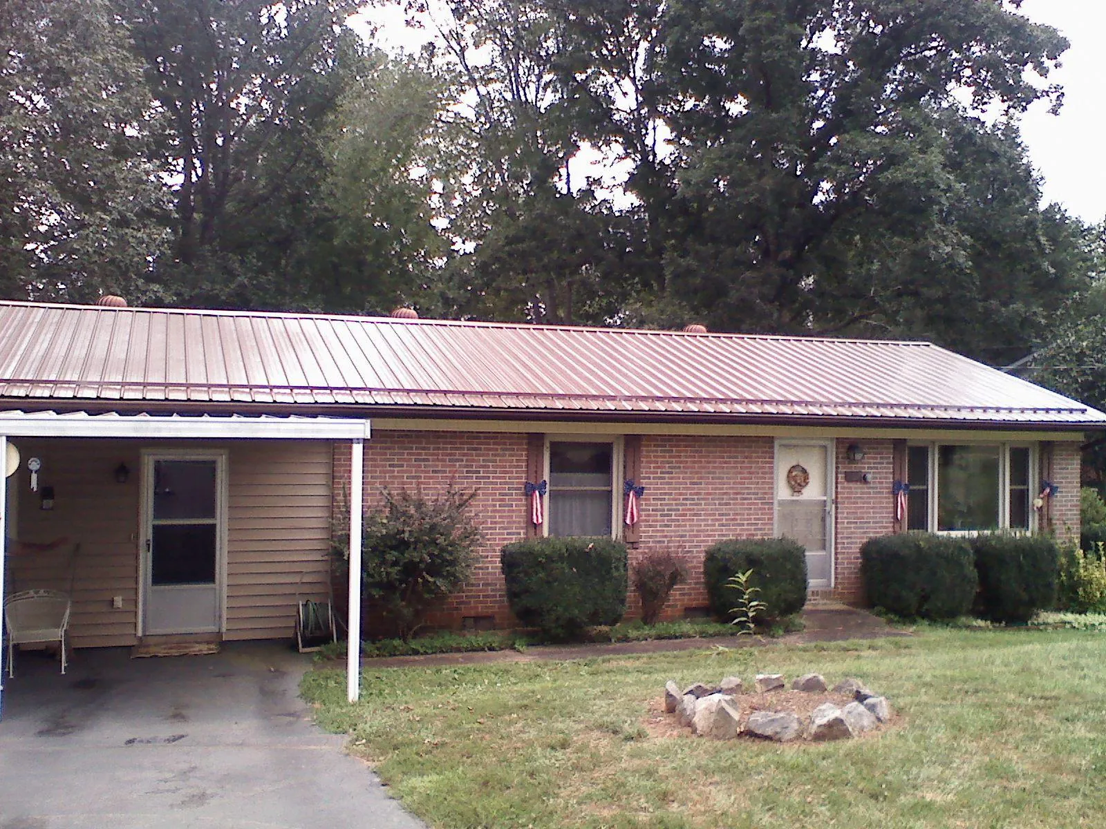 Bronze metal roof and carport on a brick ranch home — Roof Repair work by our crew in Broadway